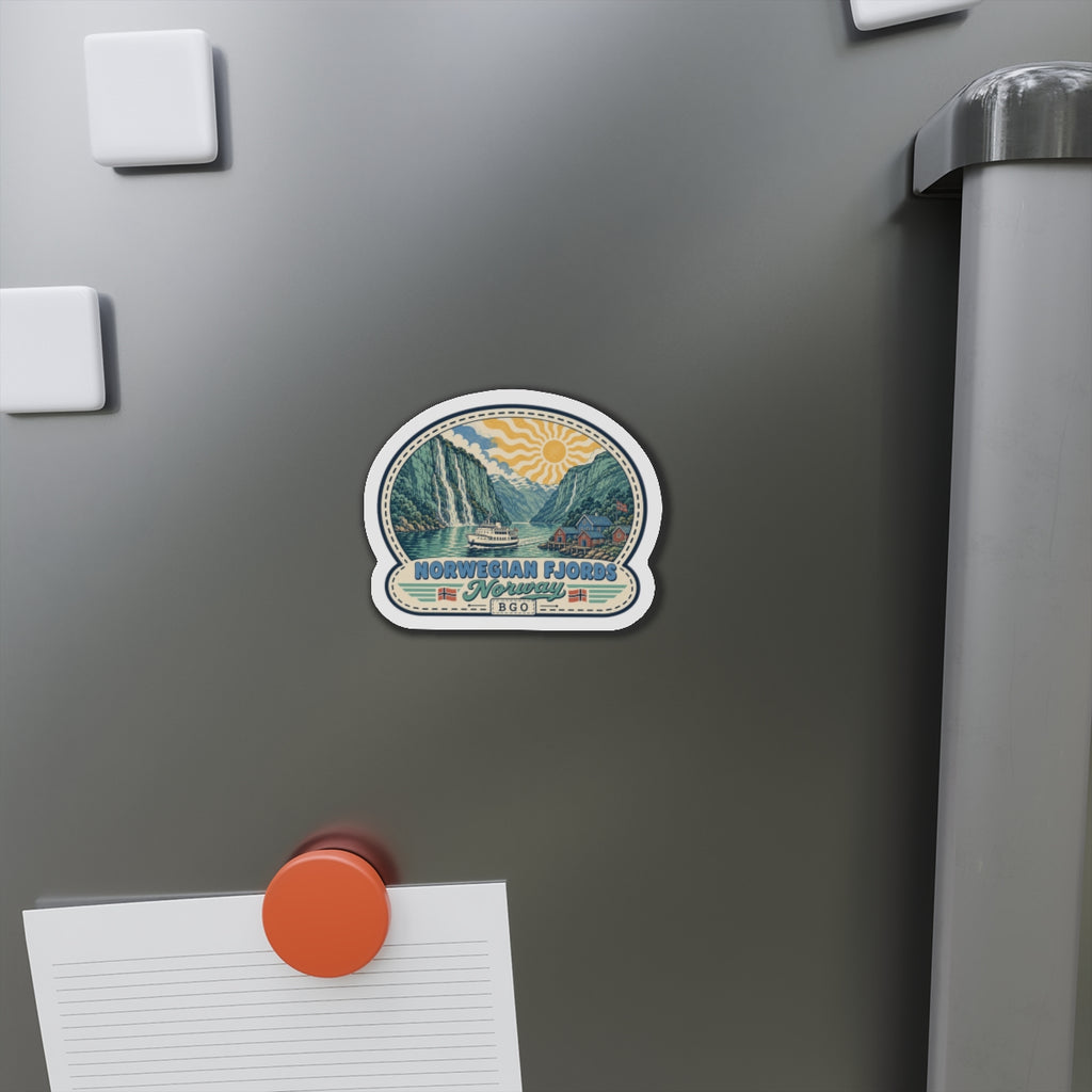 Die-cut Norwegian fjords magnet on dark refrigerator door, showing boat and mountains