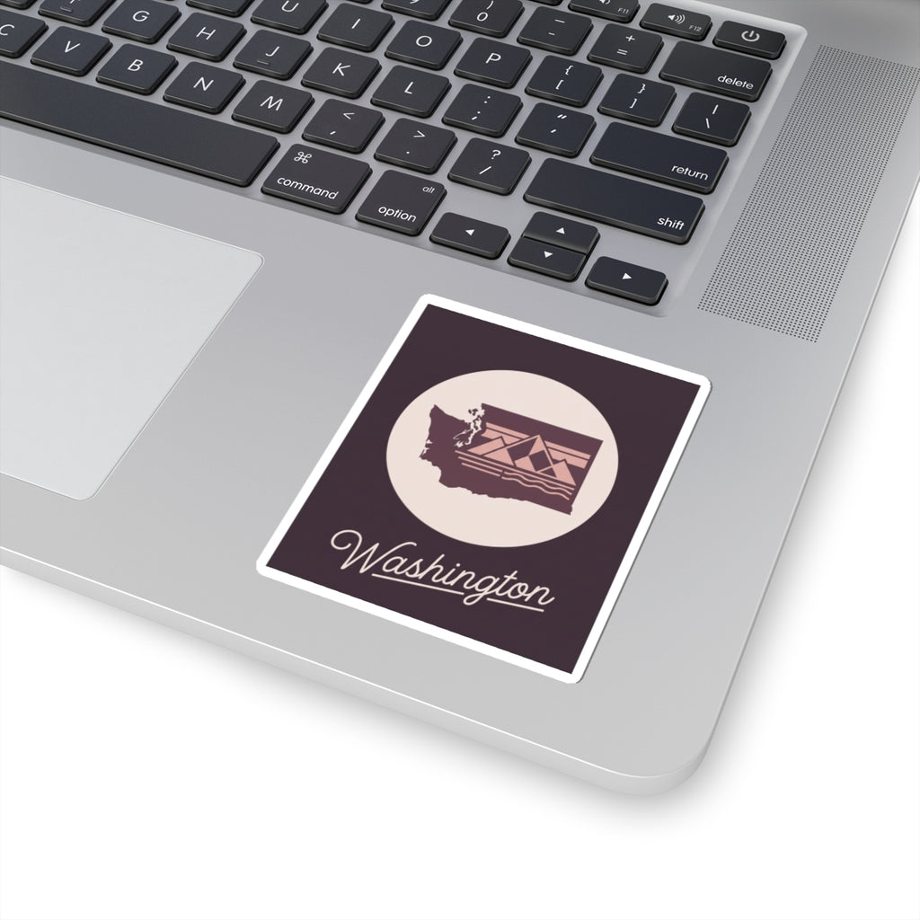 Washington state sticker placed on a laptop keyboard, round emblem with "Washington"
