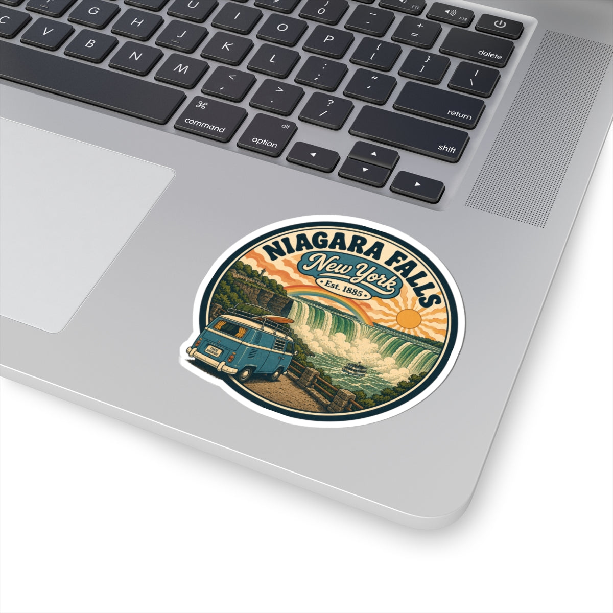 Round white kiss-cut sticker on laptop with Niagara Falls New York vintage camper van scene