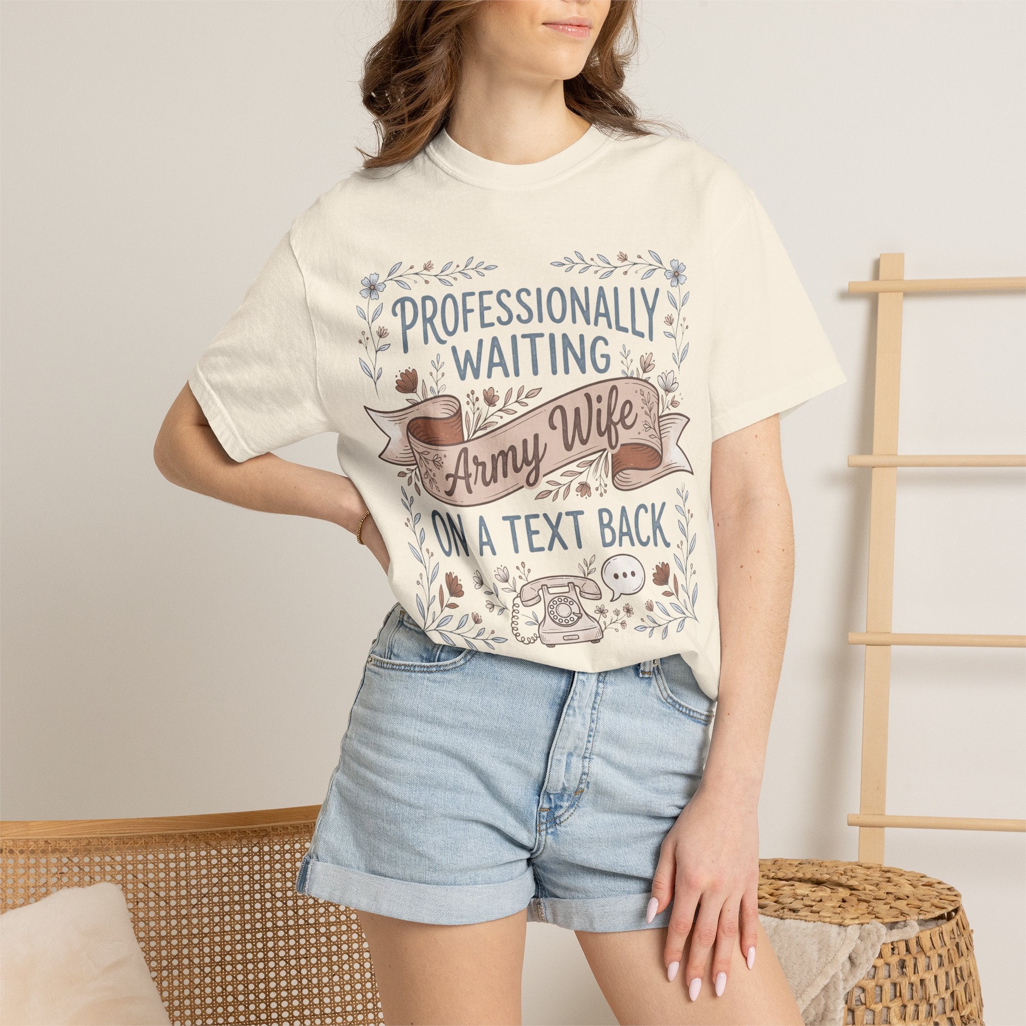 Cream t-shirt worn by model with floral ribbon 'Professionally Waiting Army Wife' text