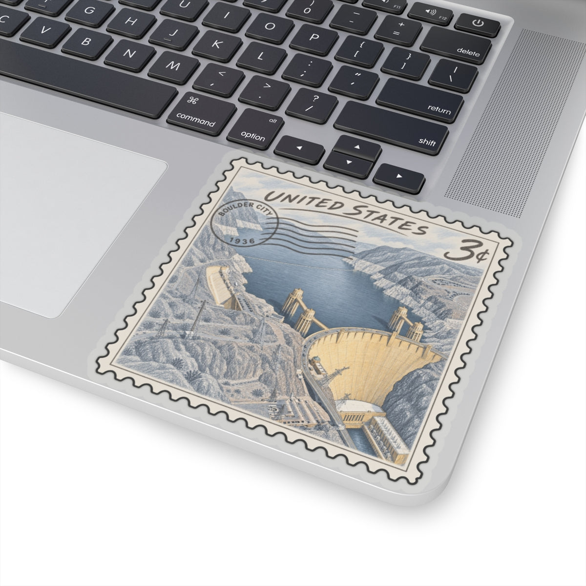 Square Hoover Dam postage-stamp sticker with United States text, blue water and beige dam.