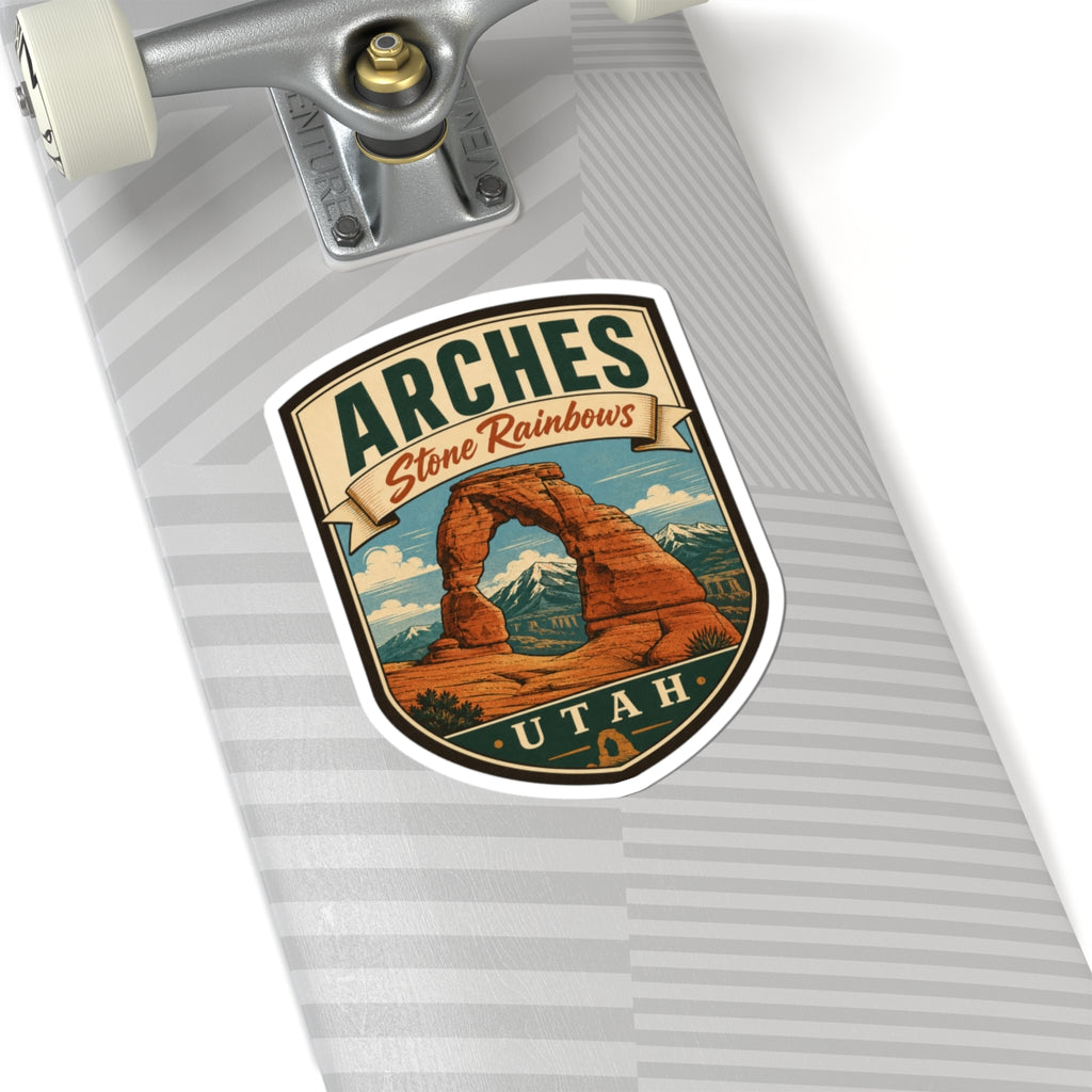 Shield-shaped Arches Utah kiss-cut sticker with Delicate Arch graphic and Stone Rainbows ribbon, close-up