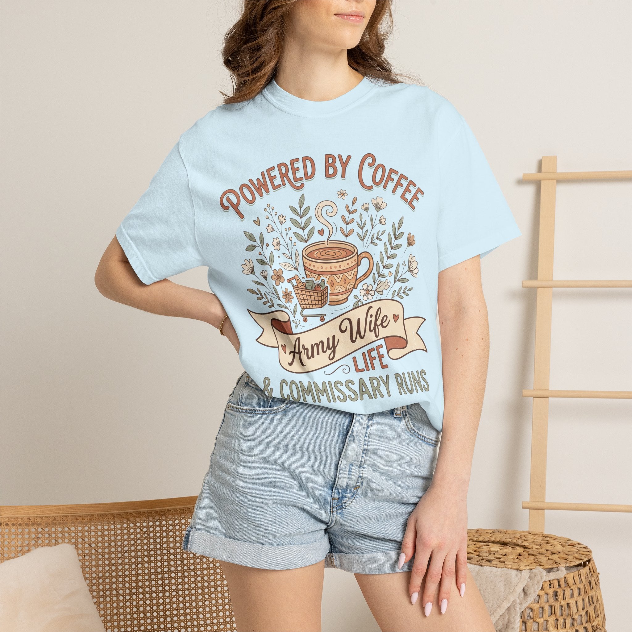Light blue T-shirt on model with Powered by Coffee graphic and coffee cup floral design