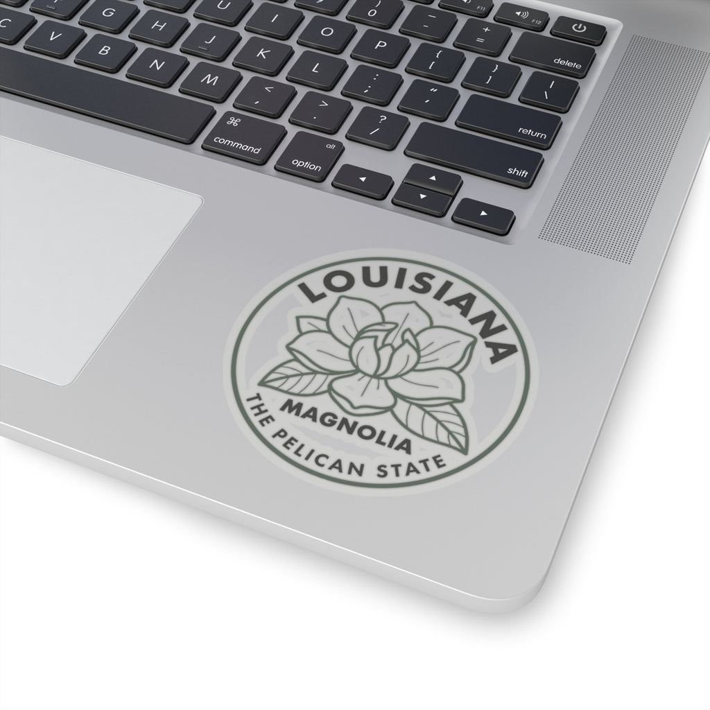 Transparent vinyl round Louisiana magnolia sticker on laptop lid, centered gray flower emblem