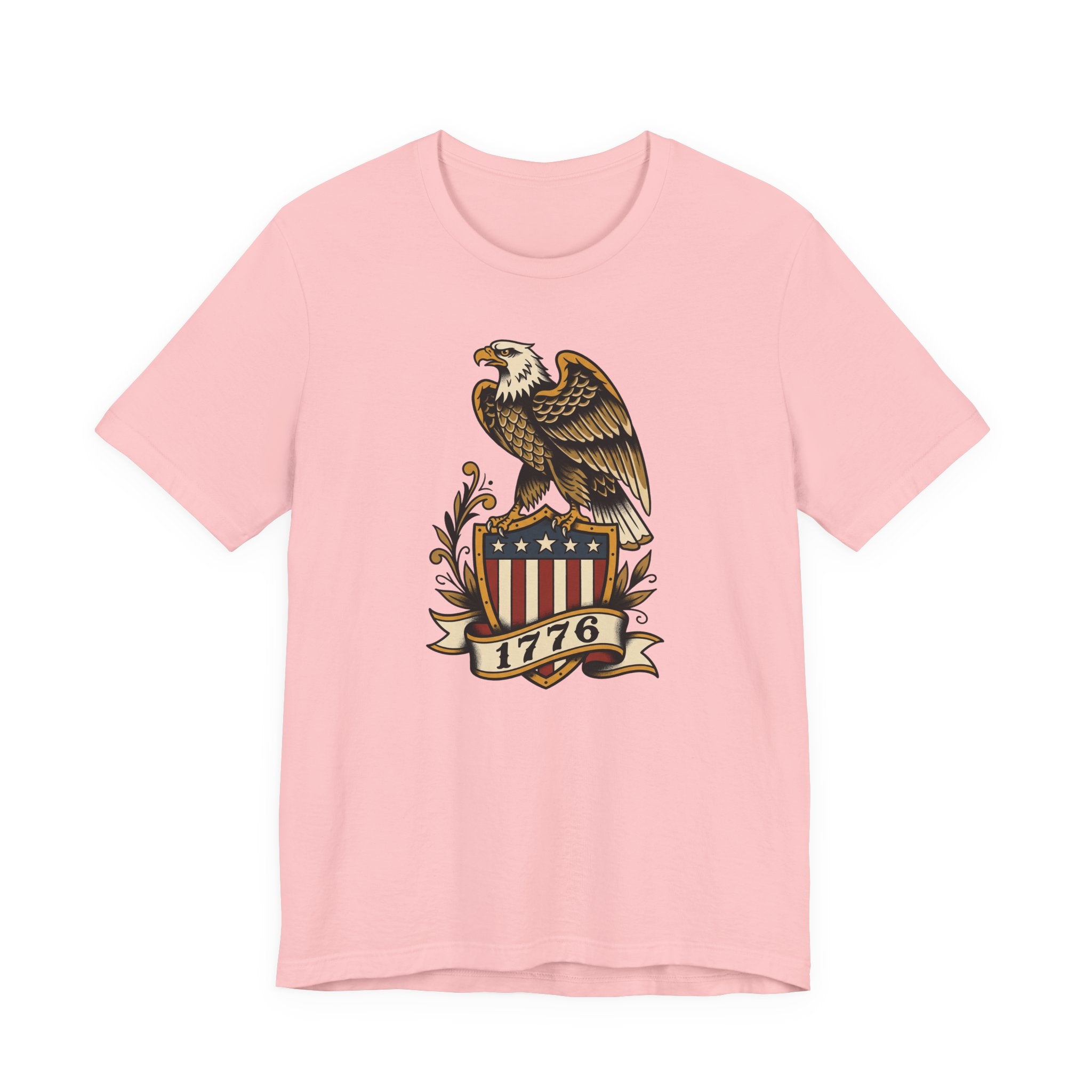 Graphic T-shirt, light pink, front features gold eagle and 1776 shield logo.
