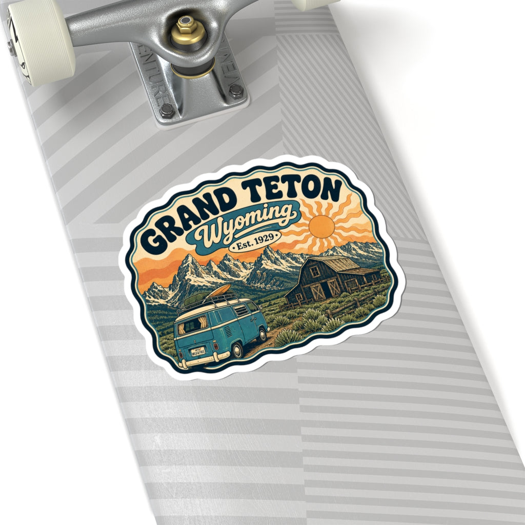 Kiss-cut sticker with Grand Teton Wyoming title, teal camper van, barn, and sunset mountains