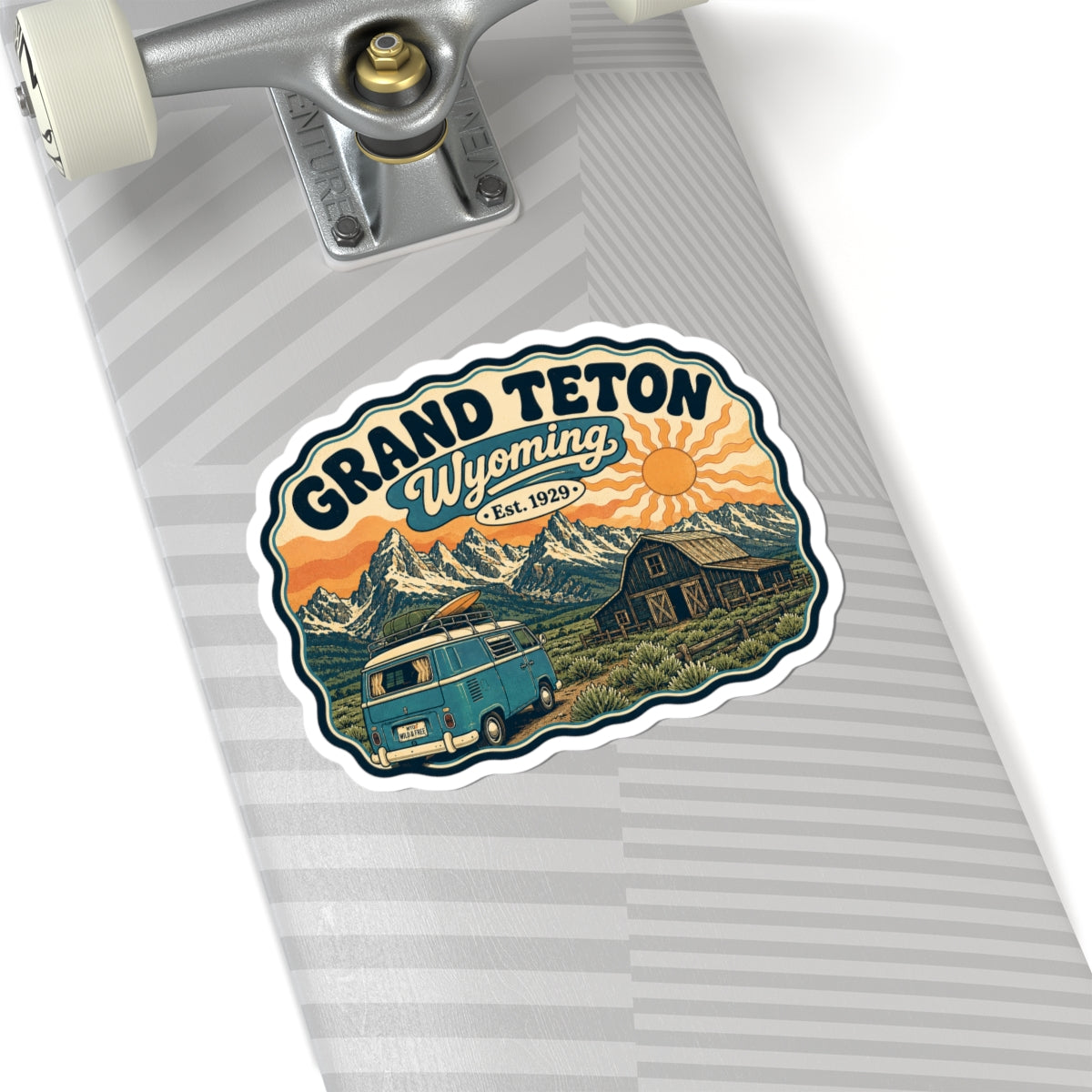 Kiss-cut sticker with Grand Teton Wyoming title, teal camper van, barn, and sunset mountains