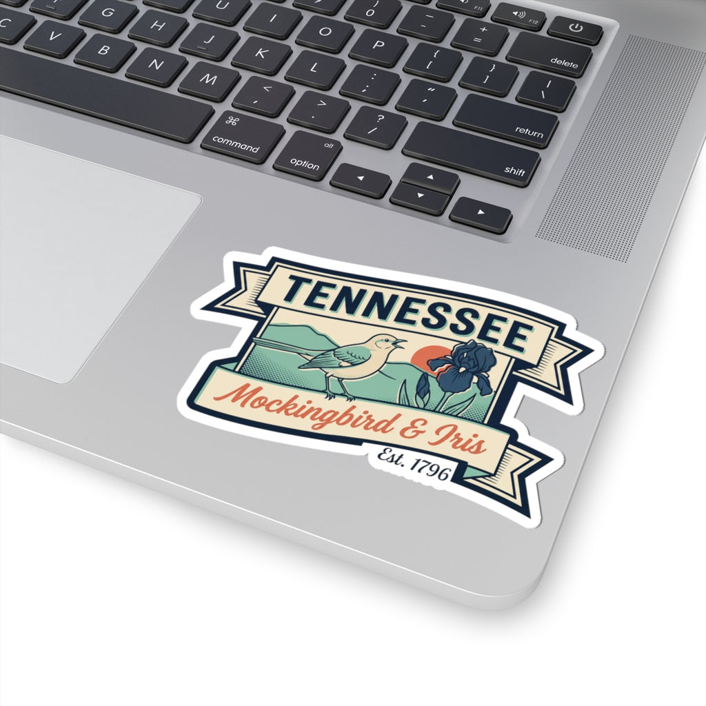 Tennessee decal sticker on a laptop trackpad area, showing mockingbird and iris