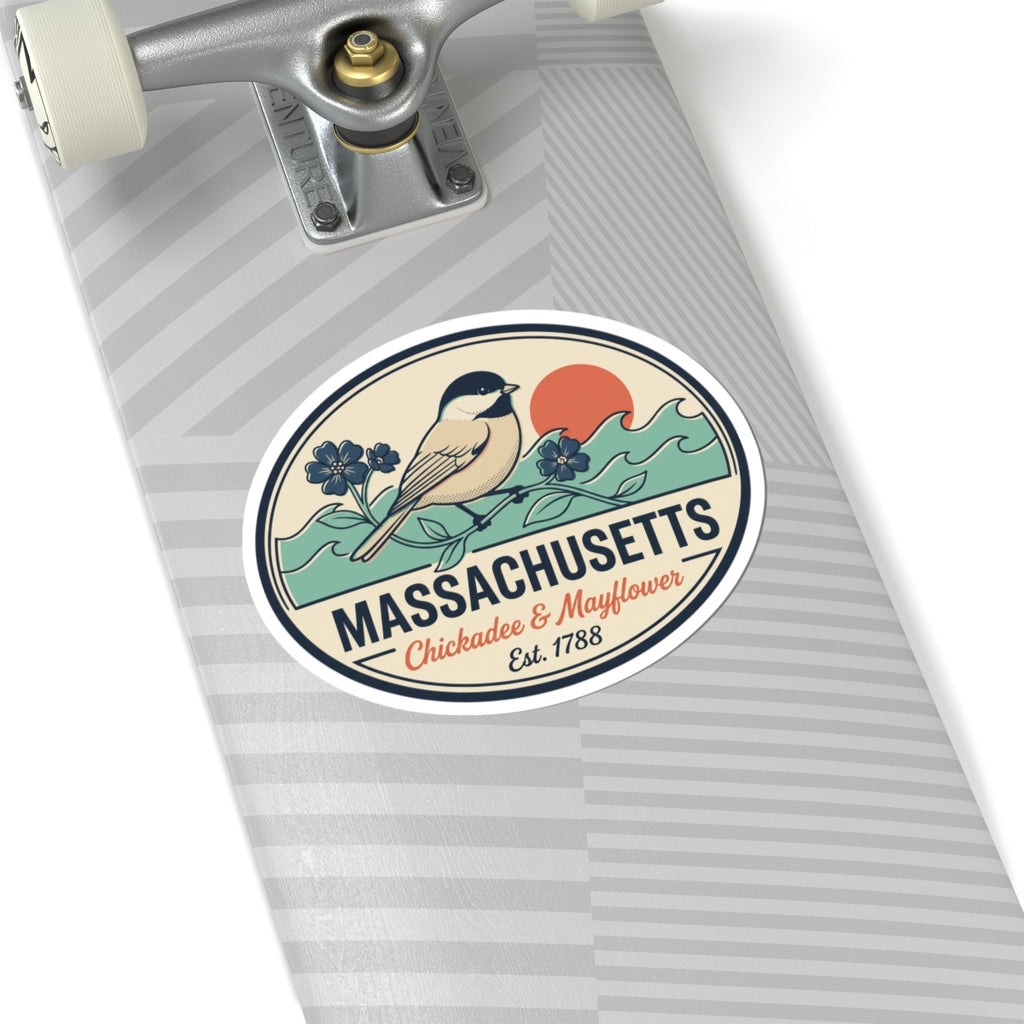 Round Massachusetts badge sticker on wrapped gift with bird, flowers, and 'Est. 1788'