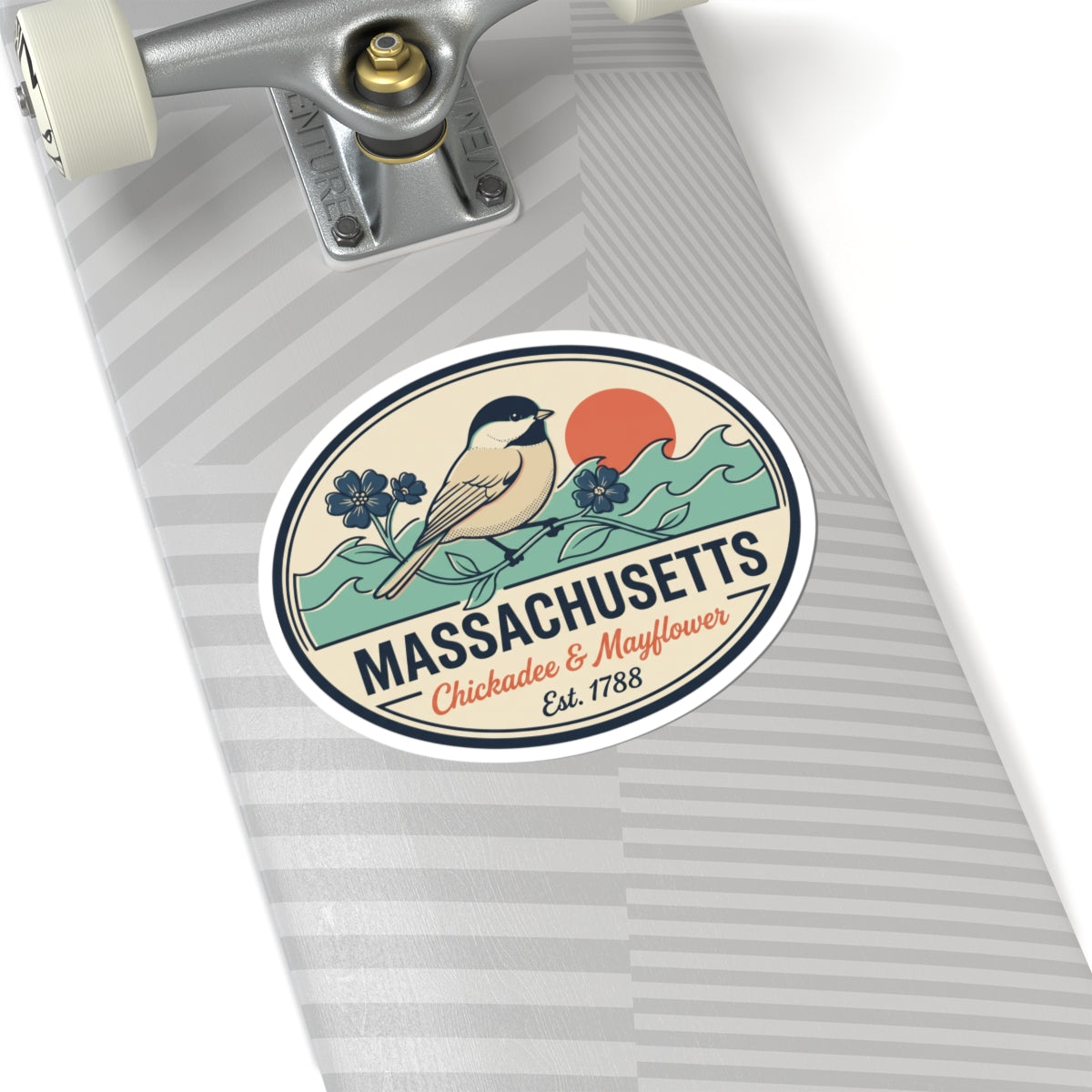 Round Massachusetts badge sticker on wrapped gift with bird, flowers, and 'Est. 1788'