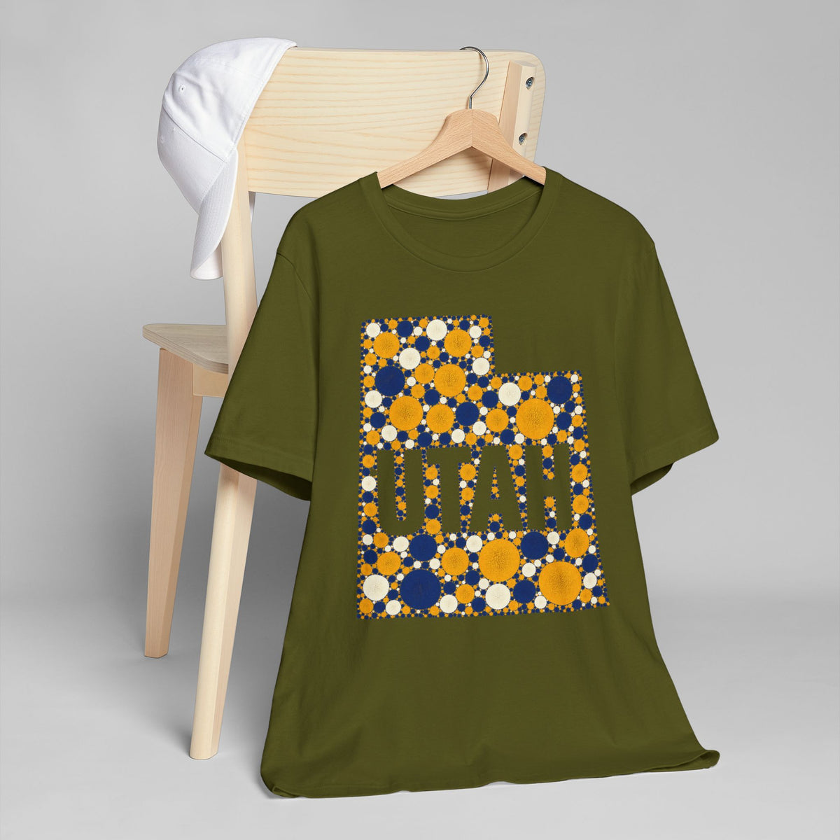 Olive green T-shirt with blue and gold polka-dot Utah map outline and lettering graphic