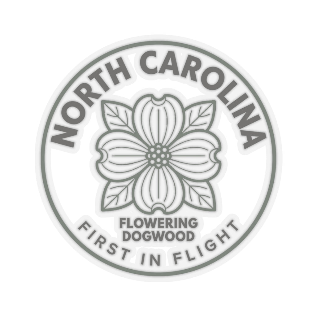 Clear vinyl dogwood sticker showing gray dogwood flower and ring text “FIRST IN FLIGHT”