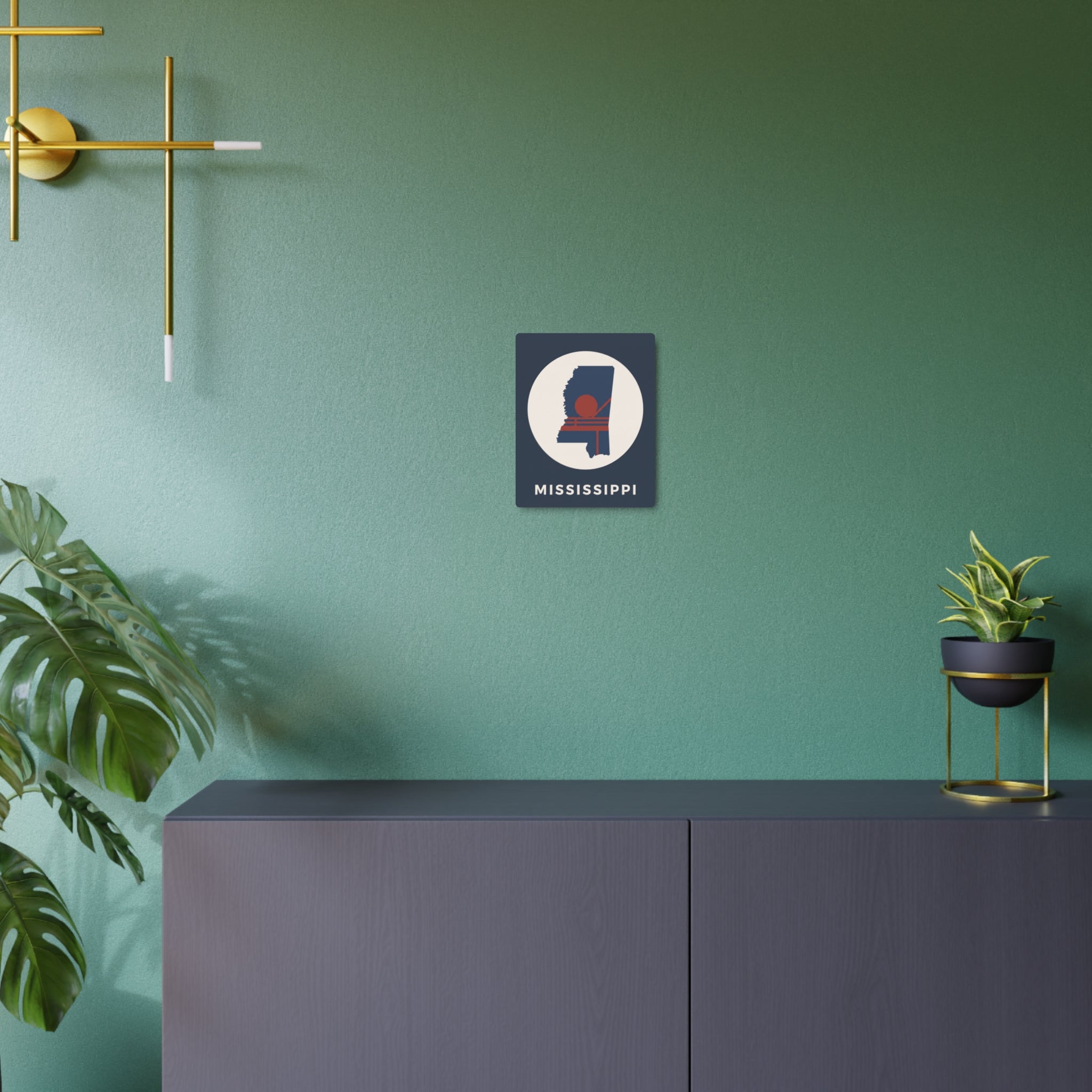 Mississippi metal art sign on teal wall: square dark blue with circular silhouette and “MISSISSIPPI”.