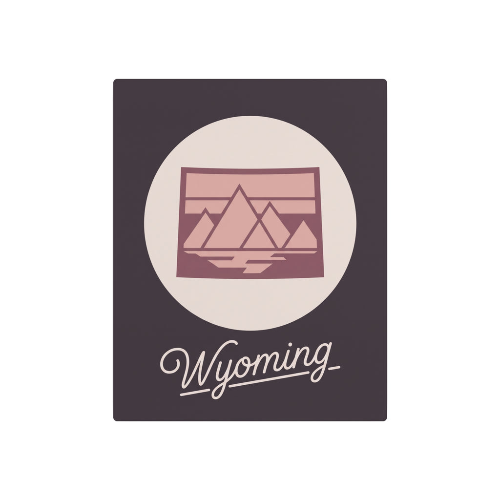 Square mauve metal wall art featuring oval landscape graphic and cursive “Wyoming”