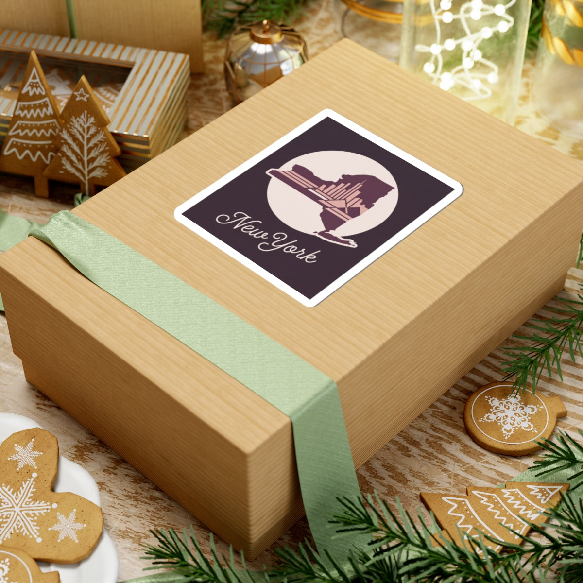 New York skyline decal sticker on a gift box top, featuring circular state silhouette and cursive “New York”.