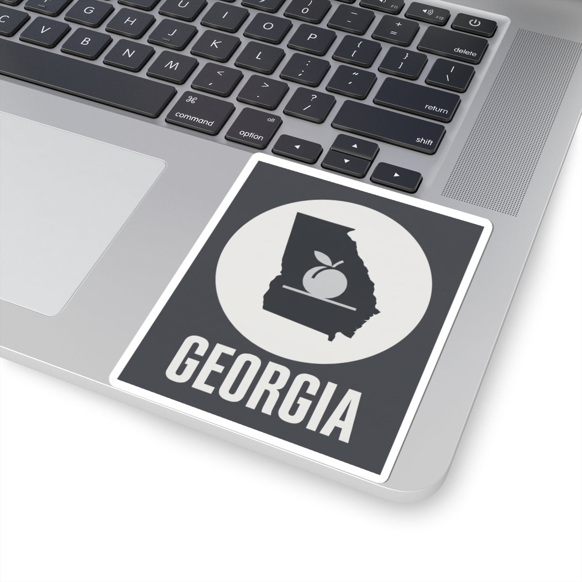 Square vinyl sticker with Georgia lettering and state outline with peach icon in circle.