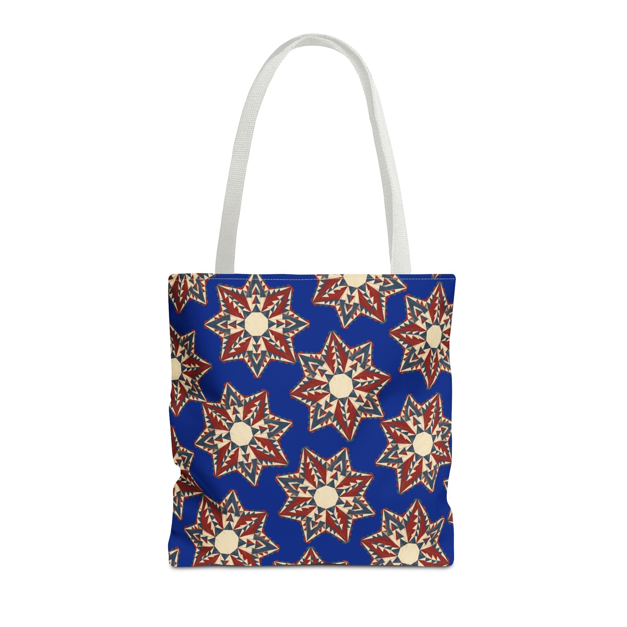 Blue tote bag with starburst floral pattern and white handles