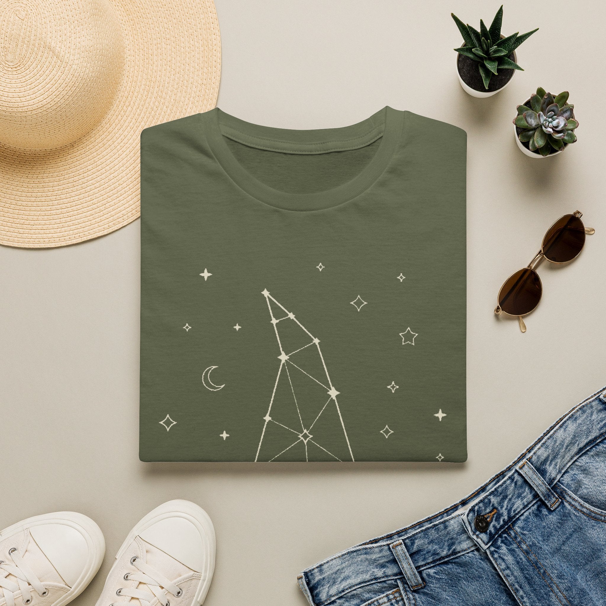 Green witch constellation graphic T-shirt with star and moon symbols