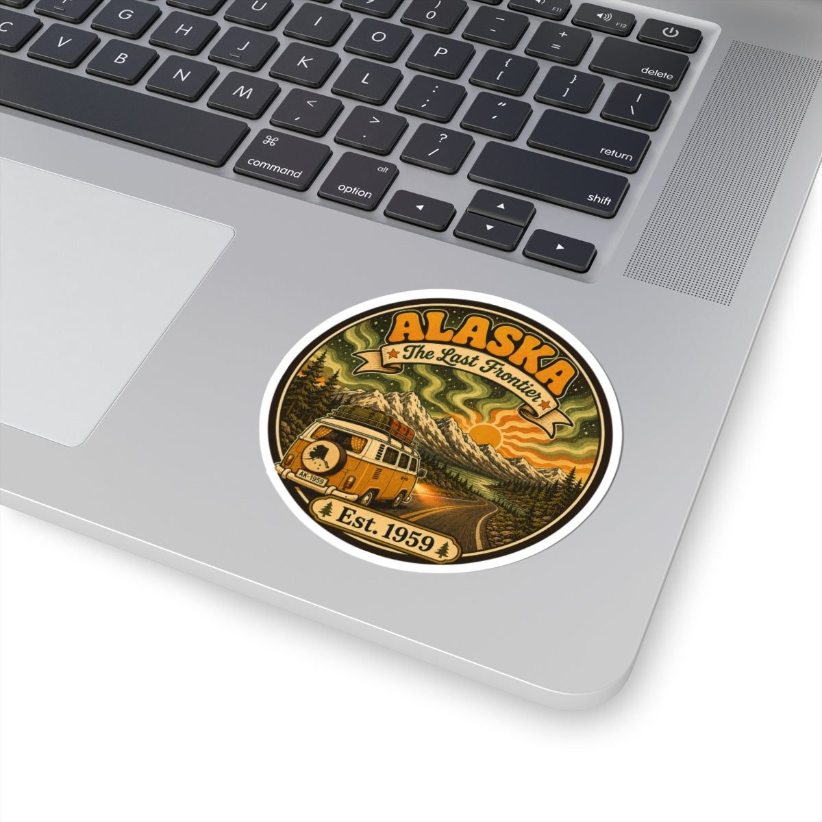 Round Alaska vintage sticker on a silver laptop lid, with camper van and Est. 1959