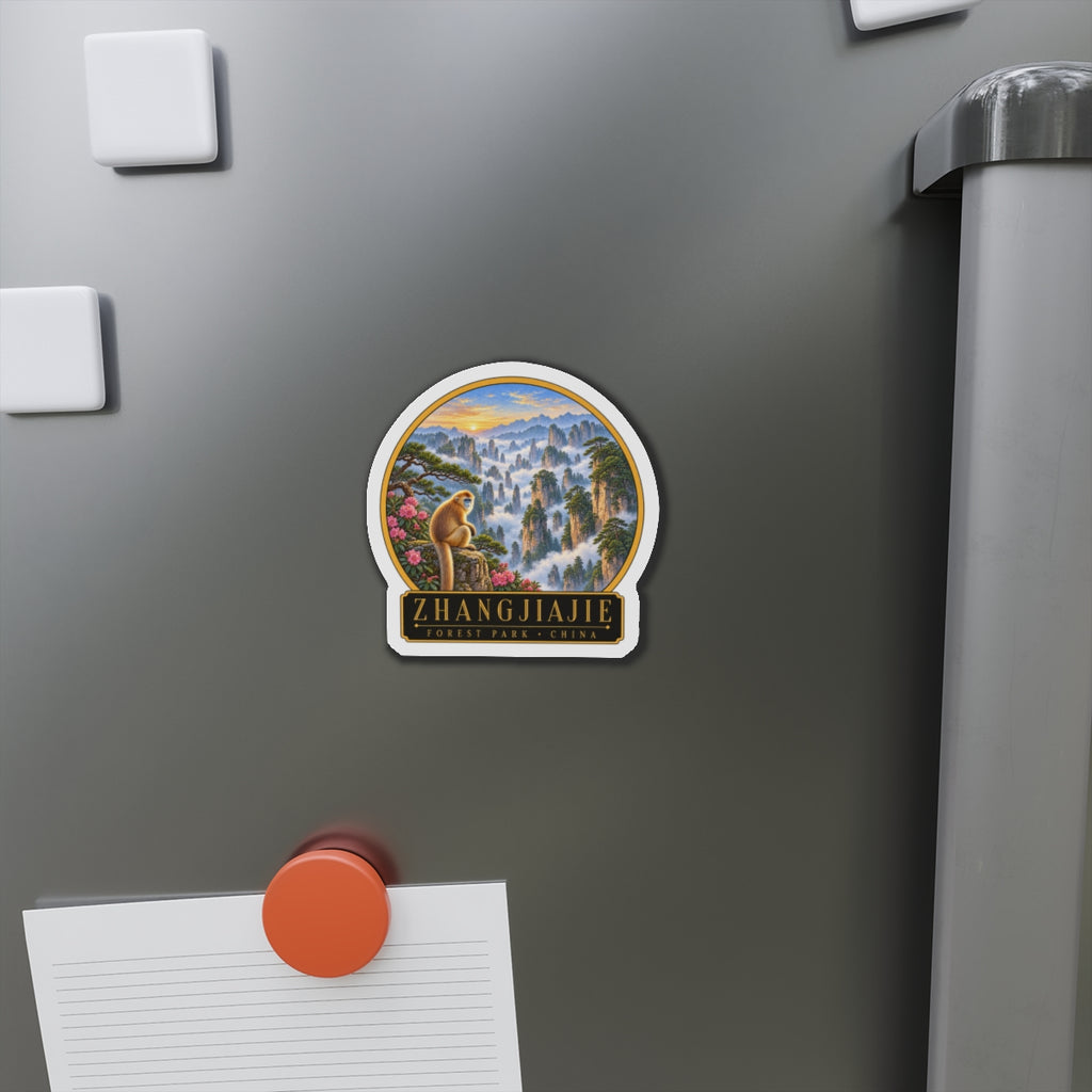 Die-cut vinyl fridge magnet on stainless fridge, showing monkey, flowers, and foggy peaks