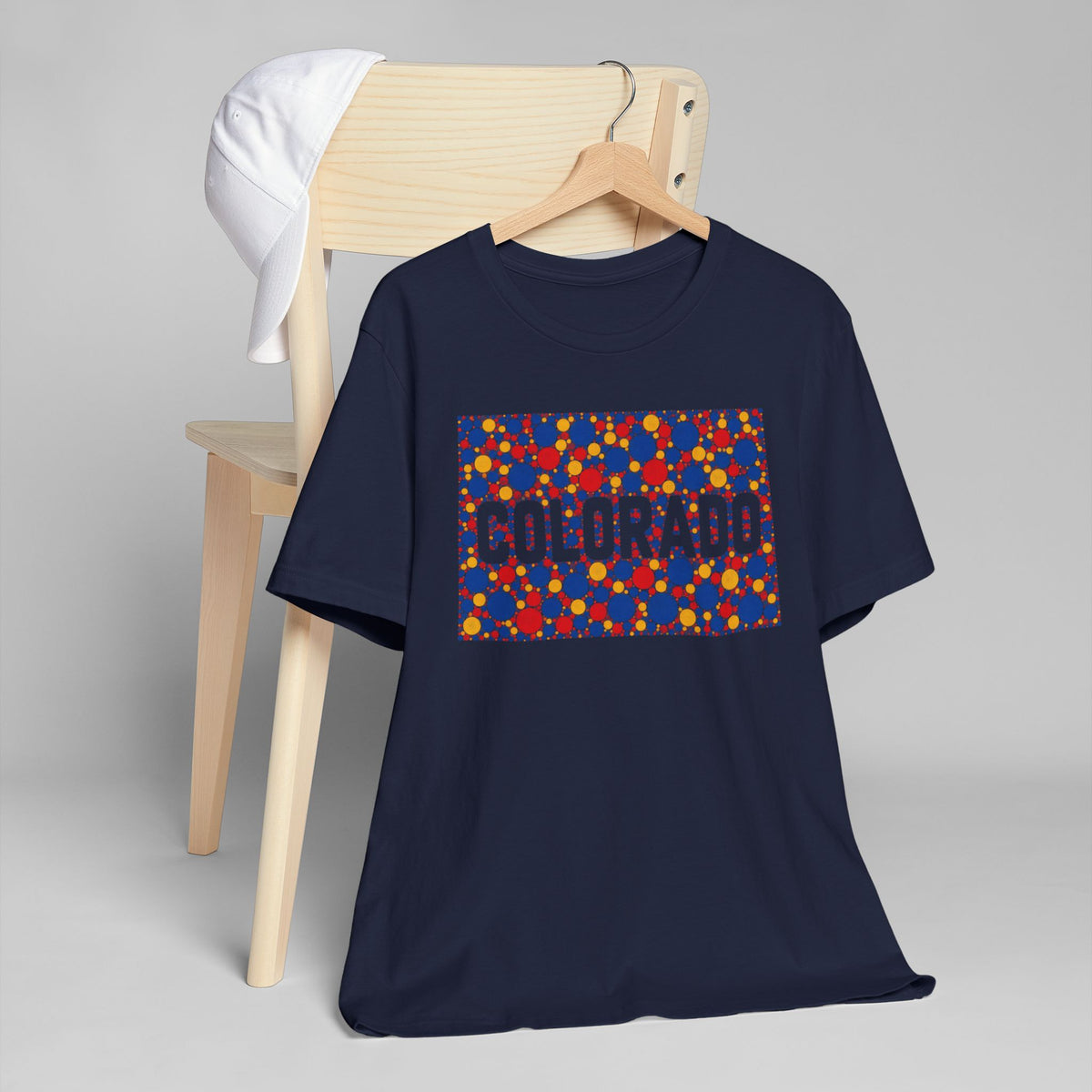 Dark blue crew-neck t-shirt with a multicolor rectangular patterned graphic on front.