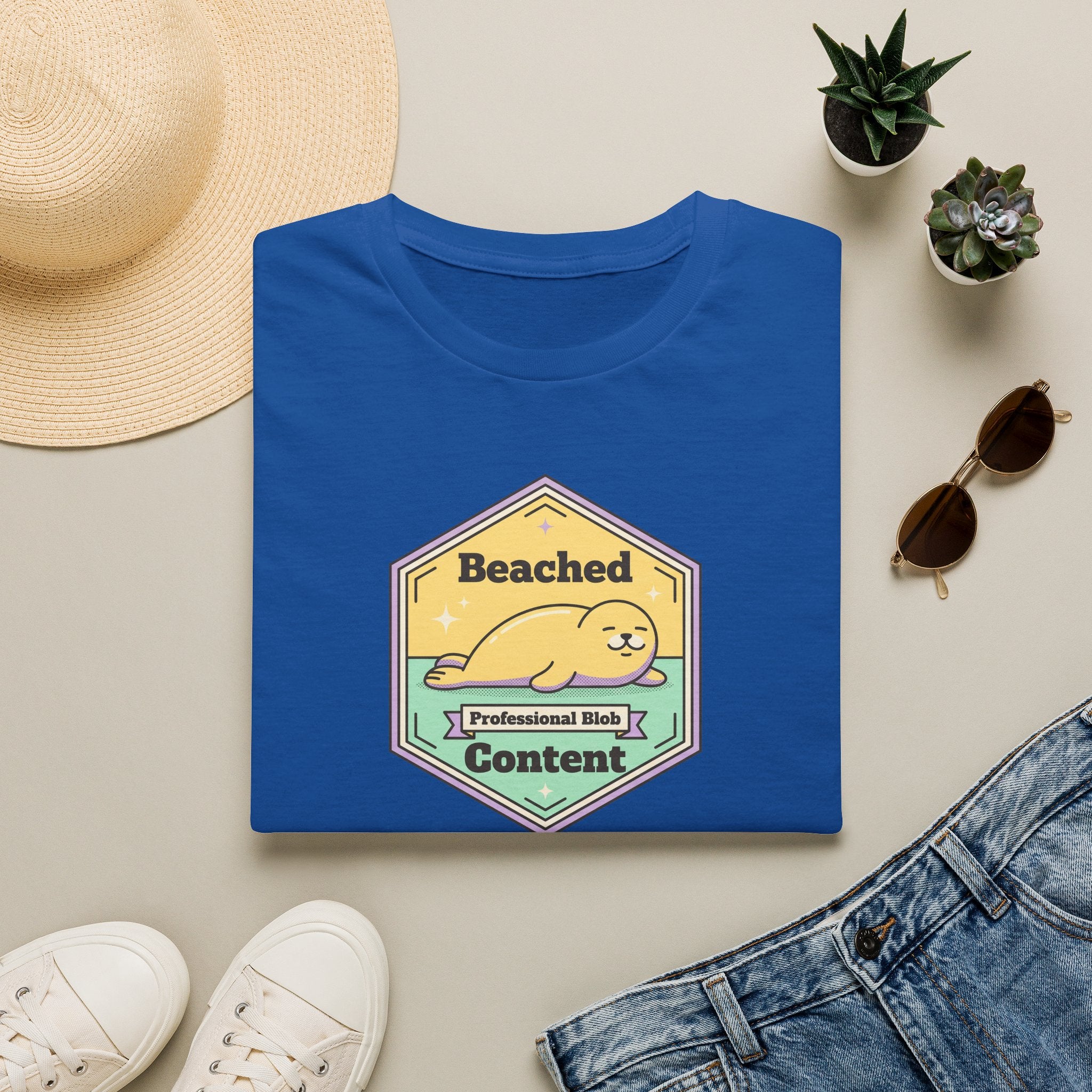 Royal blue seal badge graphic T-shirt with 'Beached Content' text