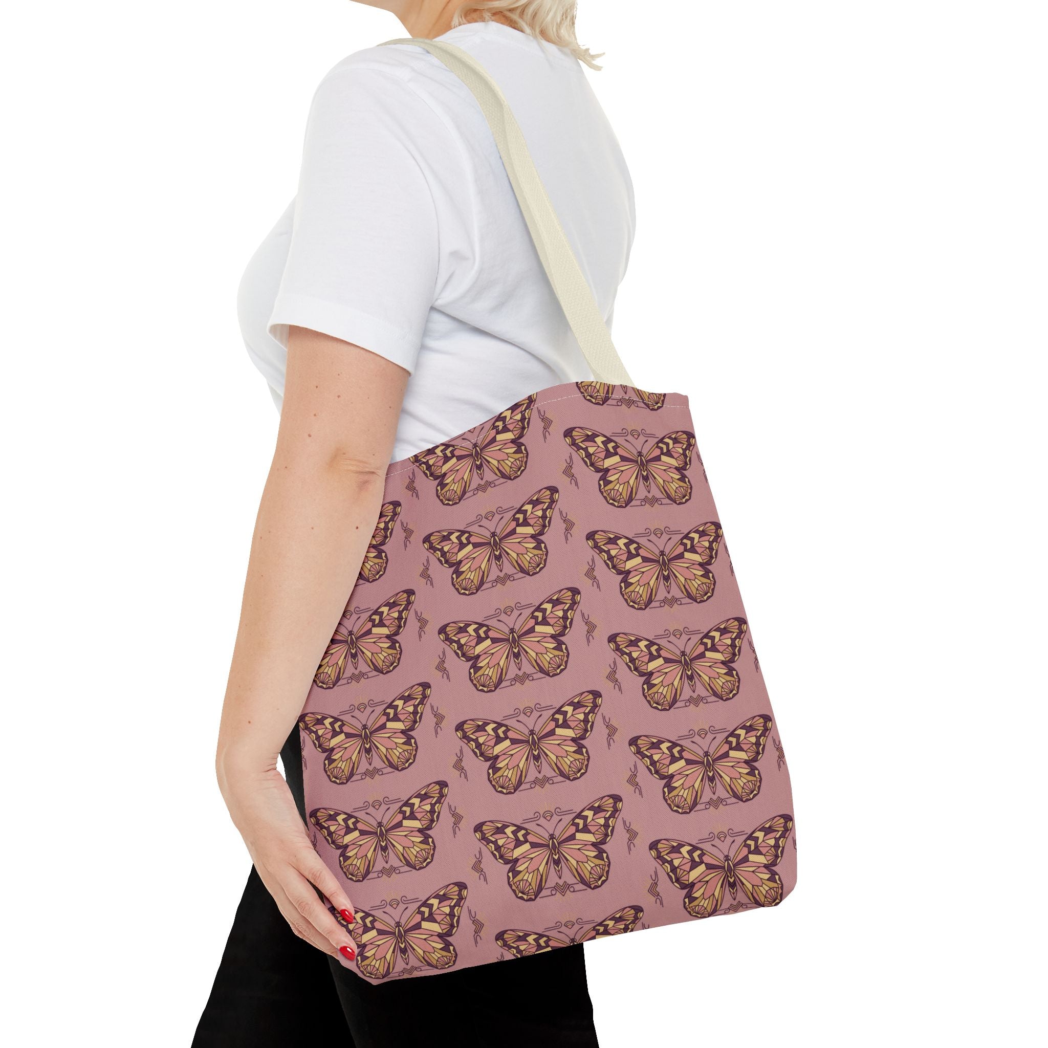 Pink butterfly tote bag with light beige shoulder strap, shown from the side