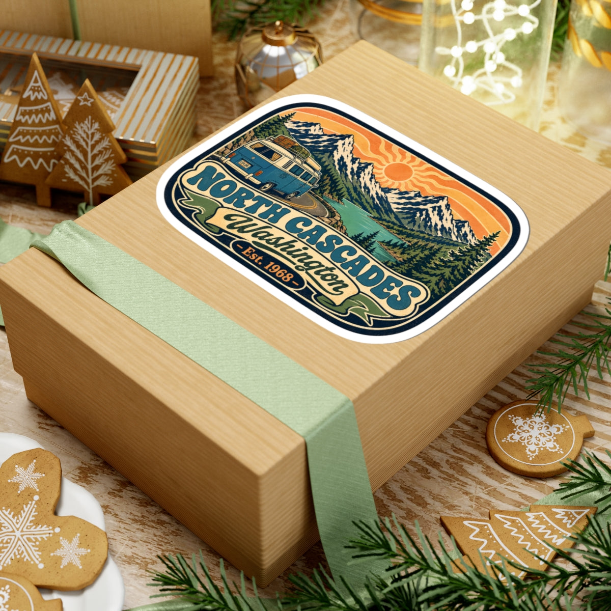 North Cascades sticker on a wrapped gift box, featuring camper van and mountain range