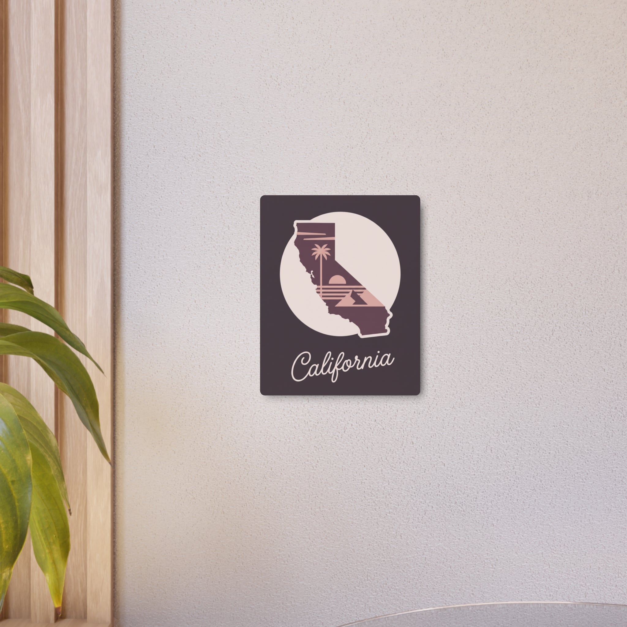 Small mauve California metal wall art square with circular palm tree silhouette and "California" script.