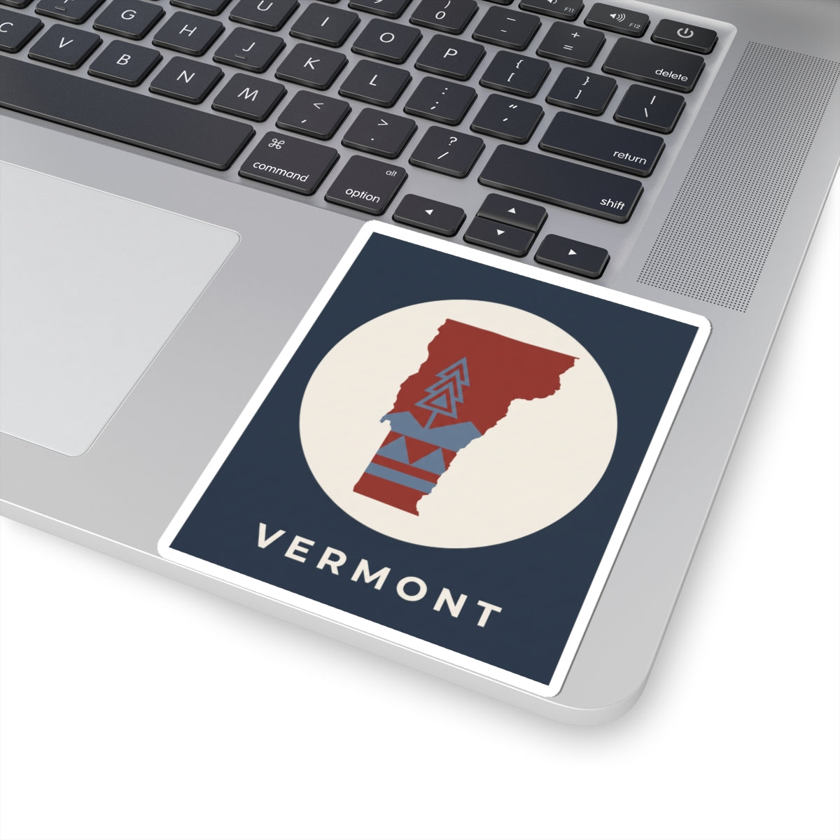 Vermont map sticker featuring red Vermont with blue mountain lines and 'VERMONT' lettering
