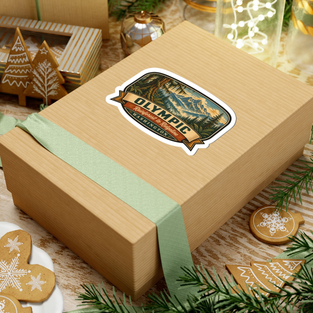 Olympic Washington sticker on a gift package with green ribbon, showing forest and mountain graphic