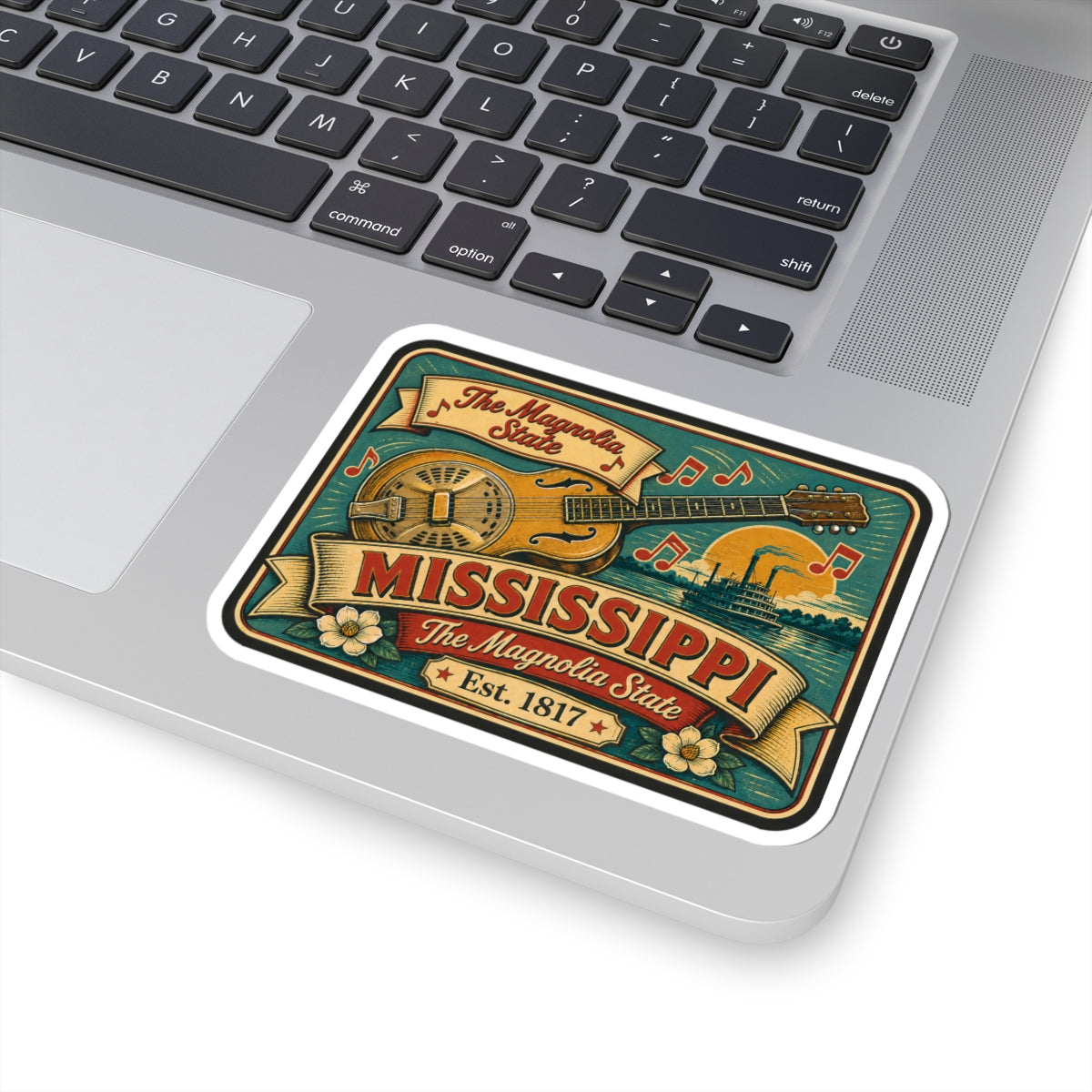 Mississippi music vinyl decal on laptop, teal banjo-guitar graphic with Est. 1817 and flowers