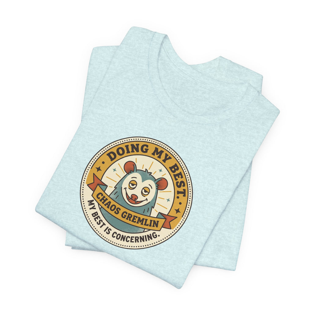 Light blue crewneck T-shirt with round cartoon gremlin badge graphic, folded layout