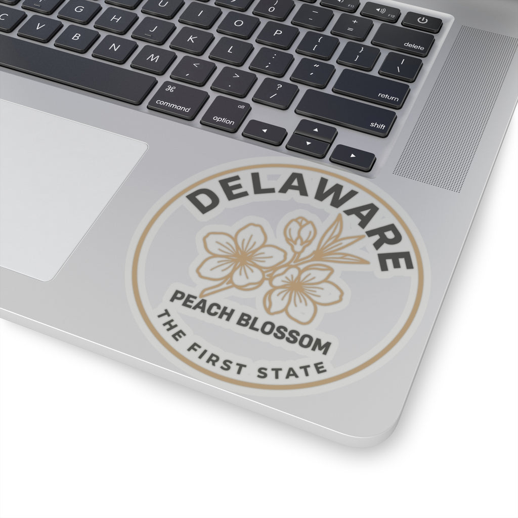 Transparent vinyl circular decal on laptop: DELAWARE PEACH BLOSSOM THE FIRST STATE