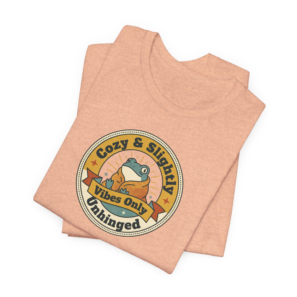 Heather peach T-shirt with round retro sloth logo graphic, folded