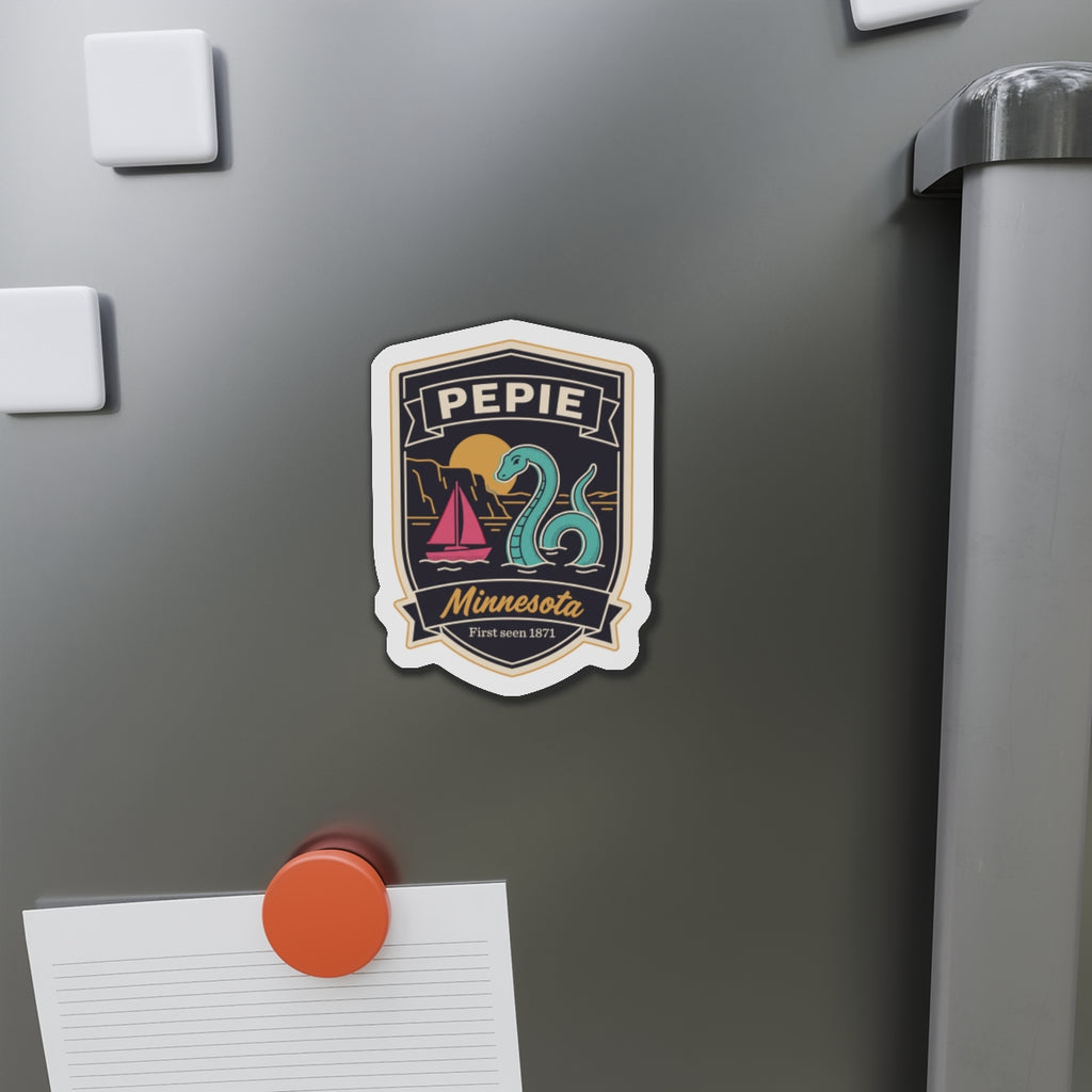 Die-cut shield magnet on stainless refrigerator door, Pepie lake monster and sailboat design