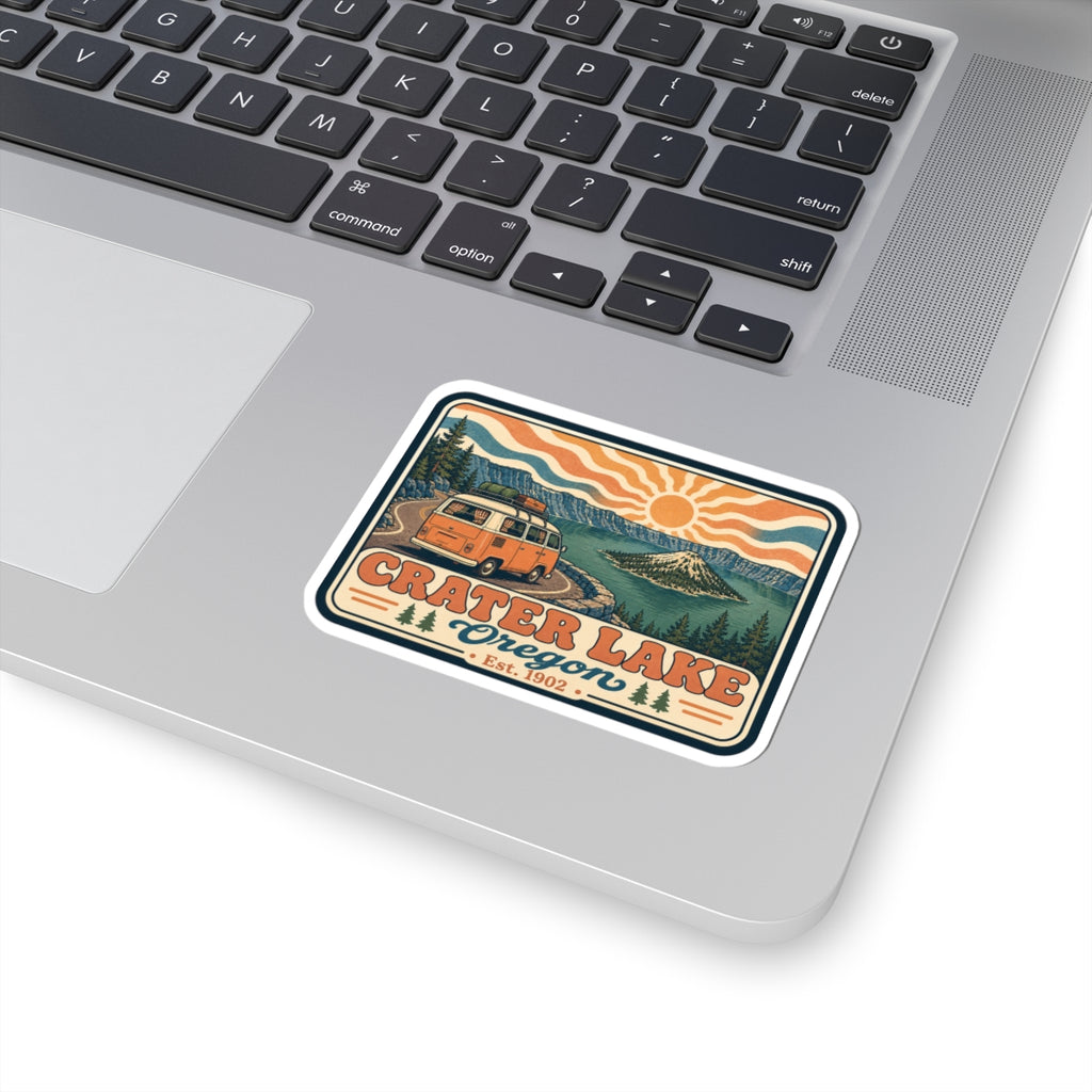 Kiss-cut sticker on laptop keyboard with retro Crater Lake Oregon camper van design
