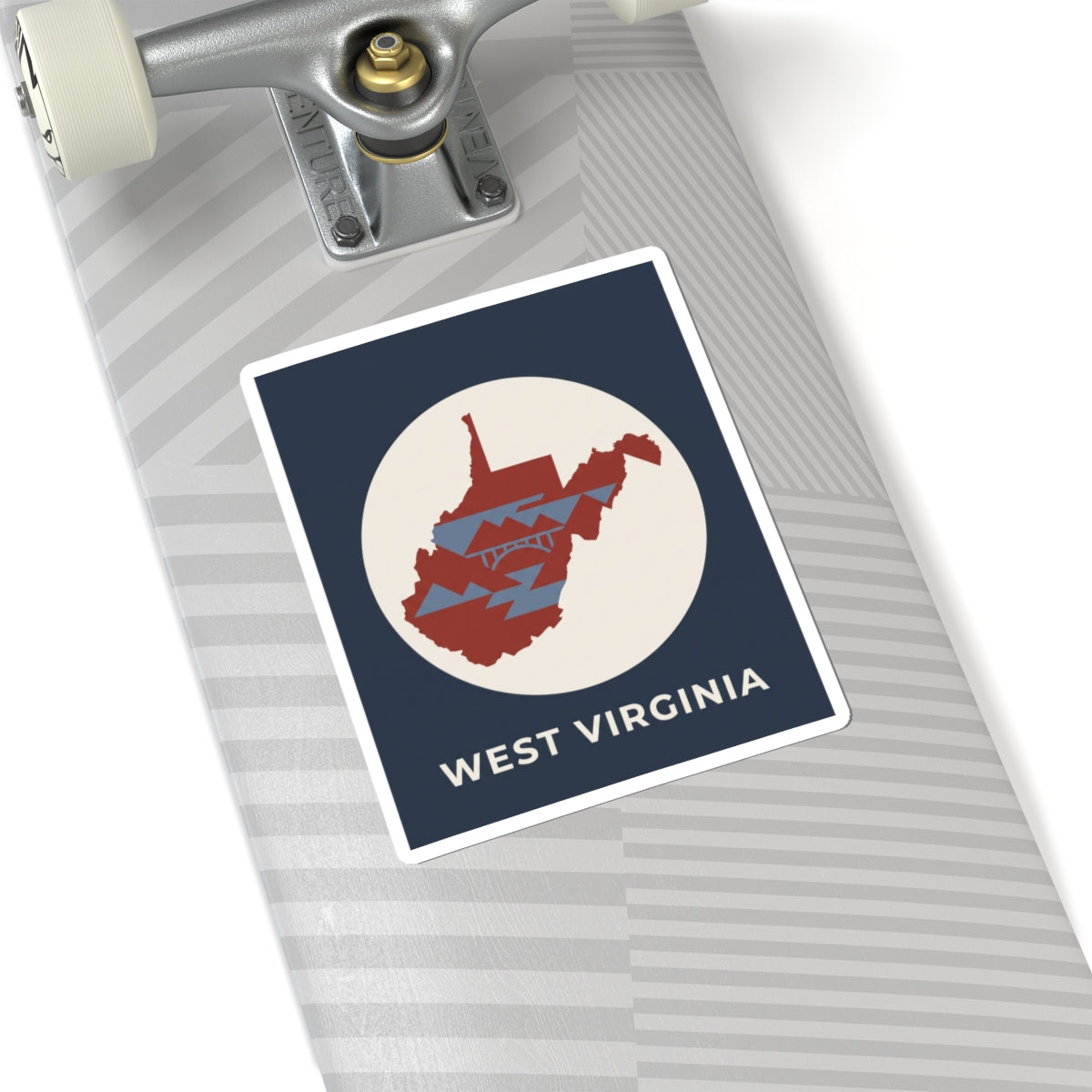 West Virginia map sticker on device surface, navy square with red state graphic and text
