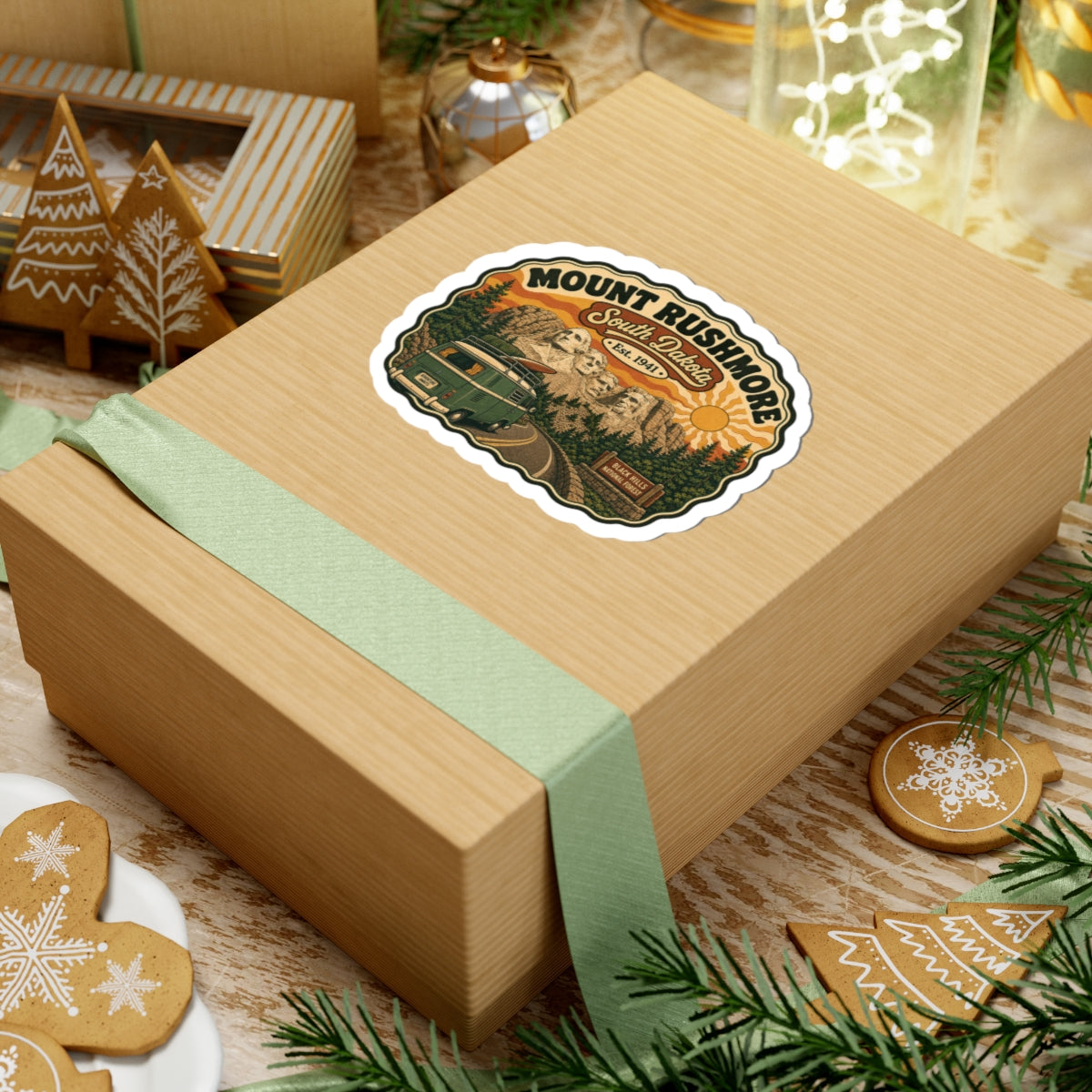 Die-cut sticker on wrapped gift box, Mount Rushmore South Dakota scene with green camper