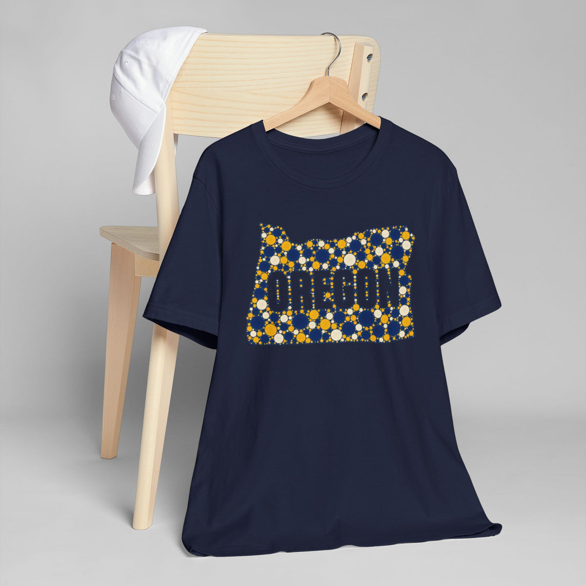 Navy crew-neck T-shirt with Oregon graphic in blue and gold dots.