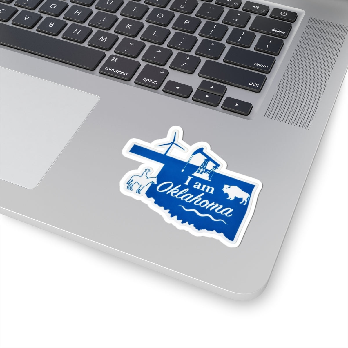 Blue “I am Oklahoma” sticker with cross, airplane, oil rig, buffalo, white outline