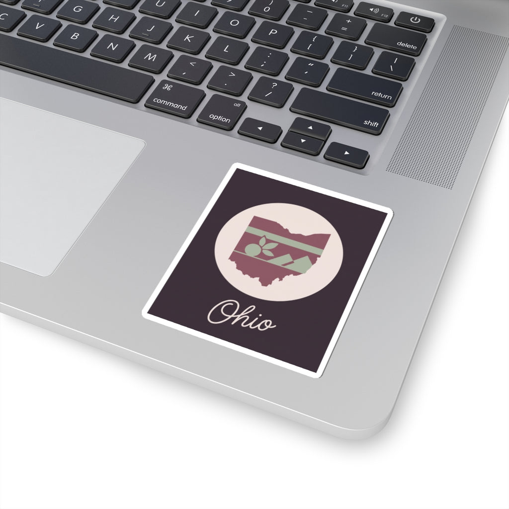 Ohio kiss-cut decal placed on a laptop keyboard; circular floral stripe Ohio map and “Ohio”