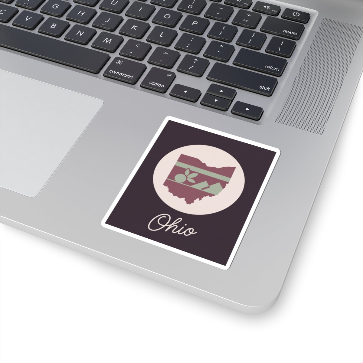 Ohio kiss-cut decal placed on a laptop keyboard; circular floral stripe Ohio map and “Ohio”