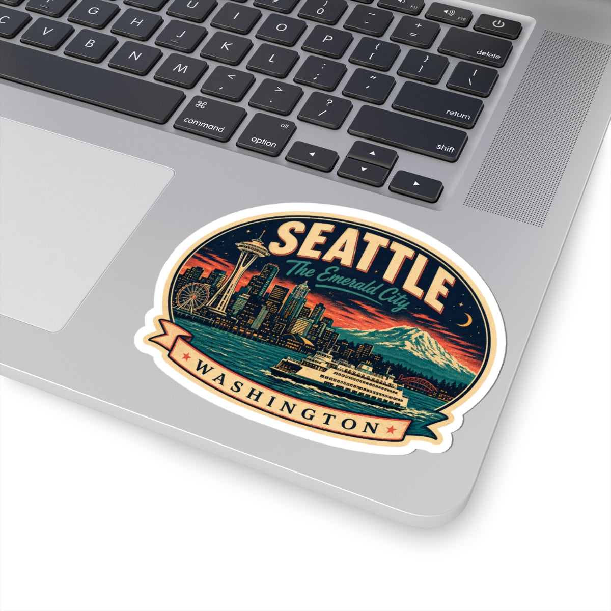 Seattle luggage tag sticker on a laptop surface, oval badge with city skyline and Mount Rainier