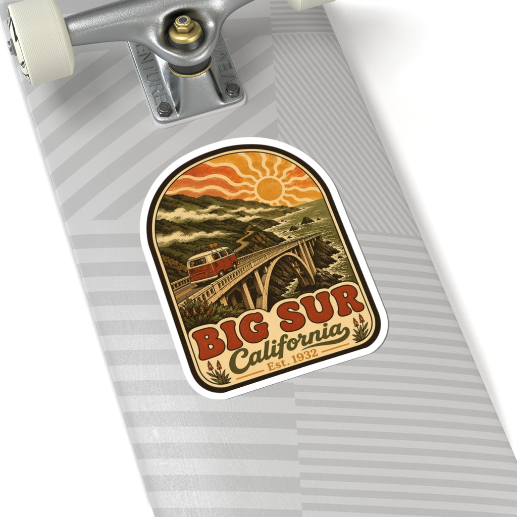 Kiss-cut Big Sur California sticker on gray striped surface, coastal bridge and red camper van art.