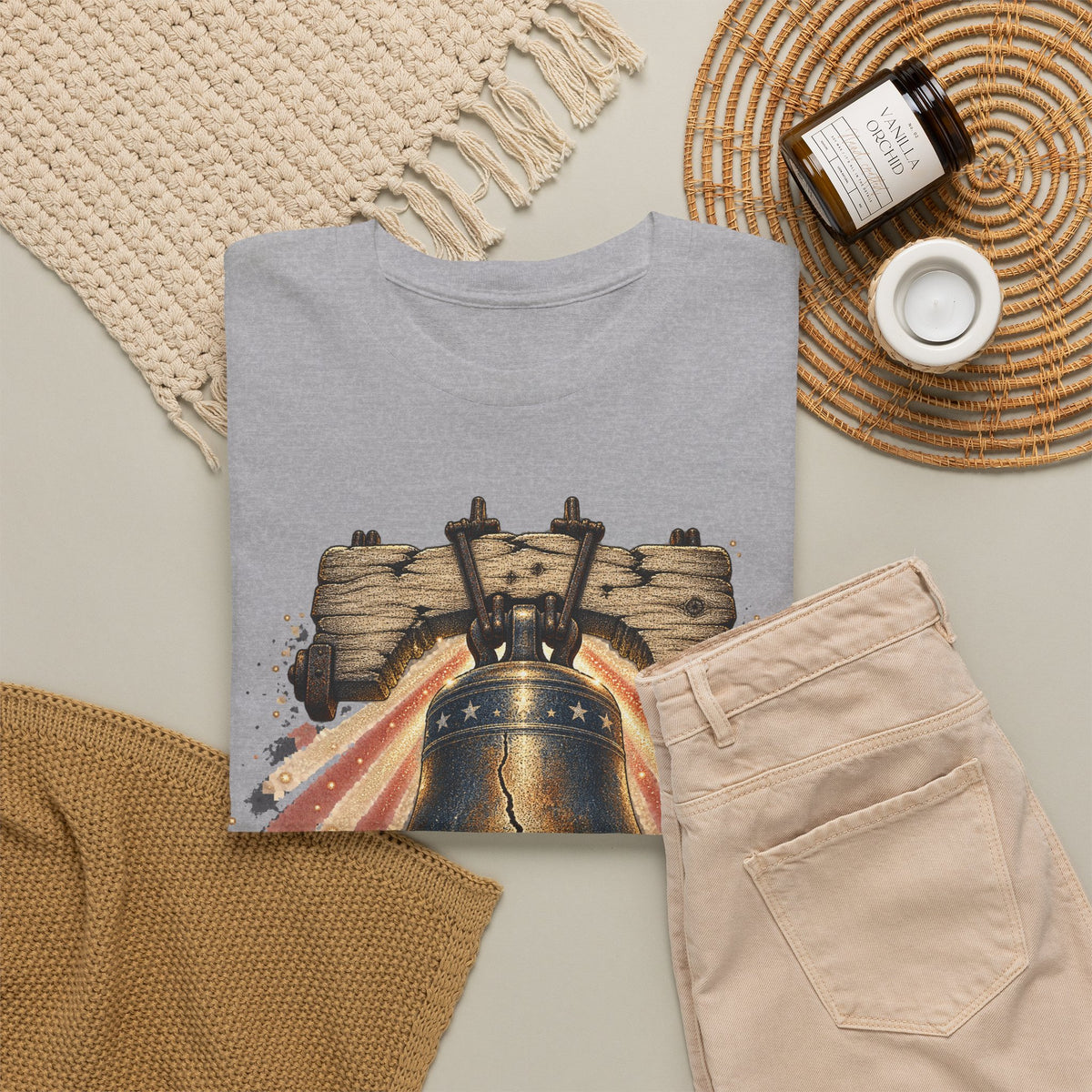 Light gray crewneck graphic T-shirt with bell and fireworks print on chest.