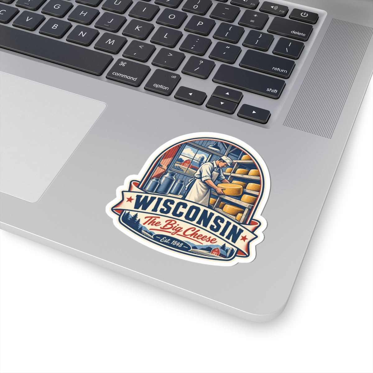 Wisconsin The Big Cheese sticker on a laptop, featuring cheesemaker and "WISCONSIN"