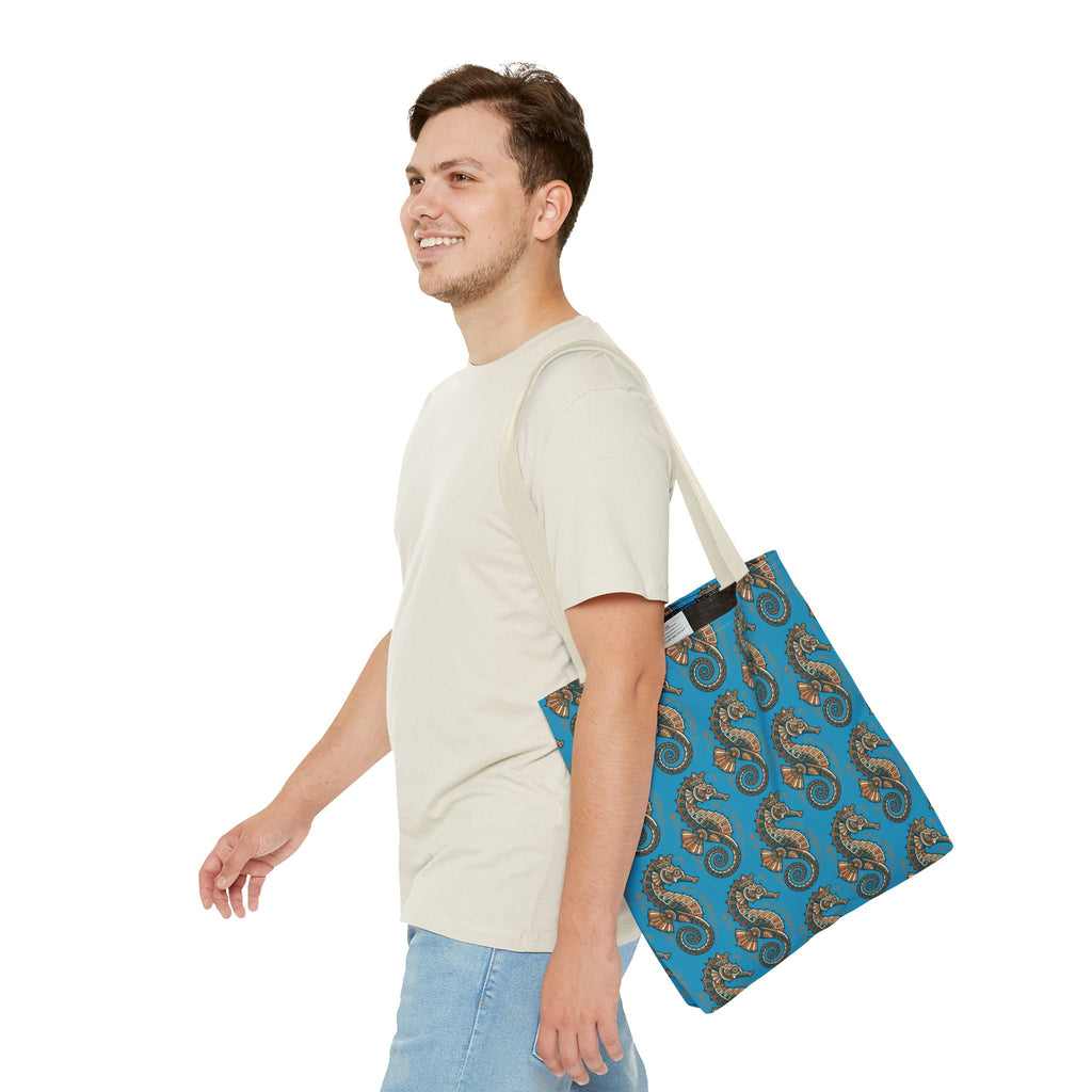 Blue steampunk seahorse tote bag with beige straps, worn over a shoulder