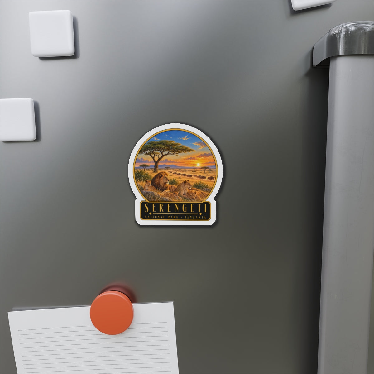 Serengeti die-cut vinyl fridge magnet on a dark refrigerator with nearby notes