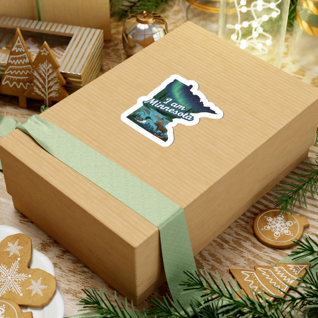 I am Minnesota sticker on gift box: aurora Minnesota with moose, lake, city